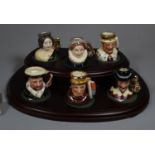 A set of six miniature Royal Doulton character jugs of historical figures to include; Henry VIII,