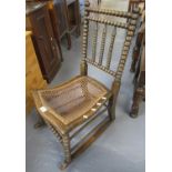 Victorian bobbin turned and cane low rocking chair. (B.P. 21% + VAT)