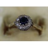 Yellow metal sapphire and diamond cluster ring. Ring size K. Approx weight 2.7 grams. (B.P. 21% +