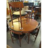 Teak G-Plan dining table of circular form with a set of six matching chairs with leather finish