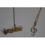 9ct gold treble clef pendant on chain and a music note bar brooch. Approx weight 4.7 grams. (B.P.