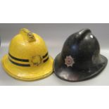 Two vintage fireman's helmets, one marked Swansea Fire Brigade. (2) (B.P. 21% + VAT)