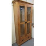 Good quality modern oak two door glazed display cabinet with adjustable glass shelves, purchased
