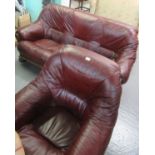 Modern burgundy ground leather two piece suite comprising; three seater sofa and matching armchair