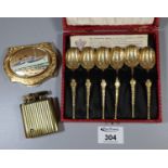 Cased set of gilded anointing spoons, a Stratton powder compact with ship motif and a brass