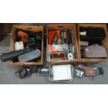 Three boxes of assorted camera equipment to include; various cameras: Cosina, Yashica, Praktica,