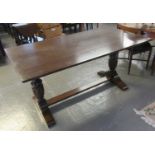 Early 20th Century oak dining table having baluster turned pedestal and stretcher support. (B.P. 21%