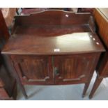 Early 20th Century mahogany bow front two door blind panelled cupboard on tapering legs and spade