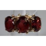 9ct gold garnet three stone ring. Ring size M. Approx weight 3.7 grams. (B.P. 21% + VAT)