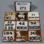 Plated circular box and cover containing an assortment of vintage enamel date and time tablets