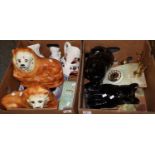 Two boxes containing an assortment of items including: two, probably 19th Century, fireside lions,
