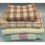 Four vintage woollen blankets; three check in various colours and one plain cream undyed. (4) (B.