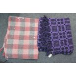 Two vintage woollen blankets, one a purple ground Welsh tapestry with fringed edges, the other a