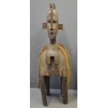 Large Western African carved hardwood female village figure/statue on four legs with cowrie