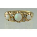 A three stone opal and diamond ring set in 18ct gold. Ring size P & 1/2. Approx weight 4.7 grams. (