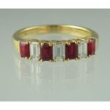 A ruby and diamond half eternity style ring of bauguette cut stones set in 18ct gold. Ring size L&