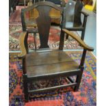 18th Century Welsh oak farmhouse splat backed elbow chair of broad proportions with solid seat on