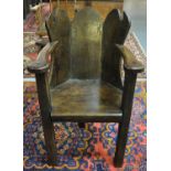 19th Century and later Welsh oak lambing chair having three section winged back, open arms and solid