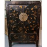 Chinese black lacquered two door cupboard, overall decorated with birds and foliage, the doors