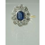 An oval Ceylon sapphire and diamond cluster ring with 18ct gold band. The sapphire approx 11 x