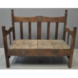West African stained hardwood slat backed settle, the open arm sides with elephant head terminals