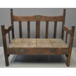 West African stained hardwood slat backed settle, the open arm sides with elephant head terminals