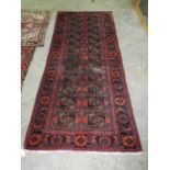 Turkman runner on an orange ground with geometric and lozenge decoration inset with flowers and