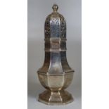 Large silver sugar castor having pierced lid, standing on an octagonal stepped base. Indistinct