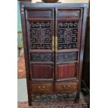 Chinese hardwood side cabinet with two geometrically pierced doors revealing shelves and short