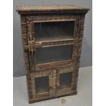 West African heavily carved hardwood side cabinet overall decorated with geometric designs;