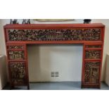 Chinese red painted fire surround with pierced panels depicting various figures amongst foliage,