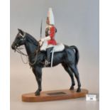 A Connoisseur Model by Beswick England 'Lifeguard' a trooper in mounted review order dressed for