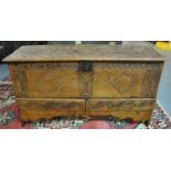18th century oak plank chest, the moulded hinged top ornately carved with flowers and foliage