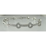 A Diamond bracelet of straight and circular links. Estimated diamond weight in total 1ct. Length