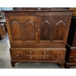 Early 19th Century Welsh oak two stage press cupboard, the moulded top above two blind panelled