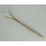 A 9ct gold cocktail stirrer. With engine turned decoration and the initials, EJ. Approx weight 6.9