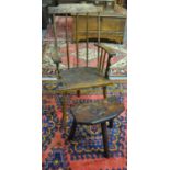 Welsh primitive style comb backed fireside armchair with solid seat on three legs, in mixed woods,