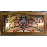 A group of three Art Nouveau design arched leaded glass panels, now in later pine frames featuring