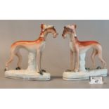 Pair of 19th Century Staffordshire pottery greyhounds with rabbit or hare prey. 18.5cm high