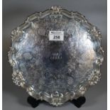 George V silver piecrust slaver, the moulded edge with shell decoration and chased floral and