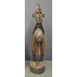 Large Western African carved hardwood male village figure/statue on pedestal