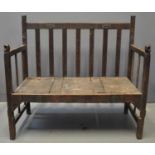 West African hardwood slat backed open armed settle, the arms with fist terminals, top rails with