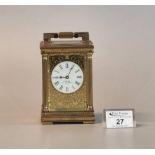 French gilt brass carriage clock with gilded face around white Roman dial marked J.W Benson, London.
