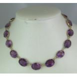 Victorian amethyst set necklace of graduated claw set stones. Length 14 inches. Approx weight 33.8