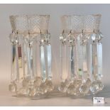 A pair of Victorian clear glass vase lustres having glass spandrels and faceted decoration, standing