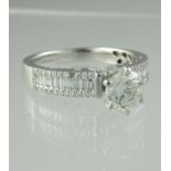 Diamond solitaire ring with baguette diamond shoulders. Ring size N. Approx weight 4.1 grams. (B.