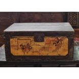 An oriental stained wooden trunk, the front panel painted with immortals amongst buildings, having