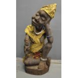 West African carved wooden mother and child figure with textiles and bead decoration, Nigerian,