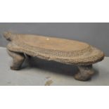 West African carved hardwood low table in the form of a crocodile with overall chip carved