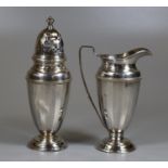 Early 20th century silver two-piece cased set comprising helmet shaped milk jug and matching pierced